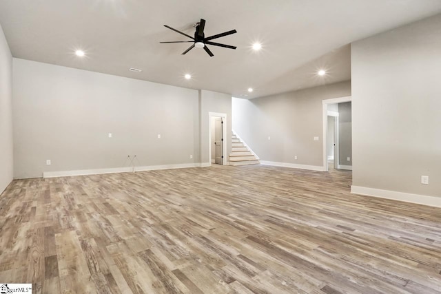 unfurnished room with light wood-type flooring and ceiling fan