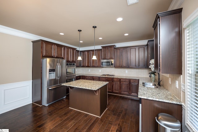 kitchen with light stone counters, stainless steel appliances, sink, dark wood-type flooring, and decorative backsplash