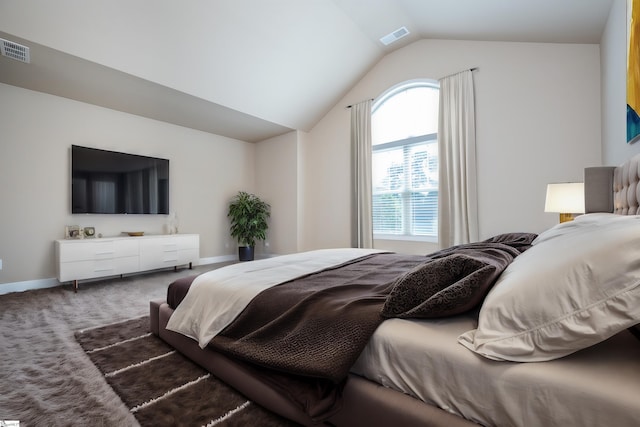 bedroom featuring dark colored carpet and vaulted ceiling