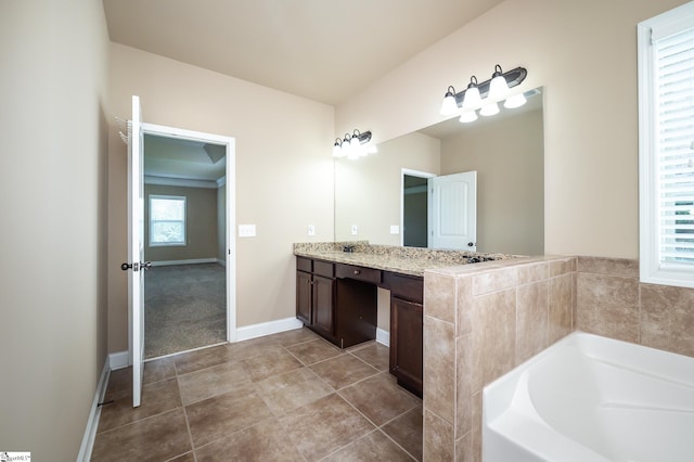 bathroom featuring vanity, a bathing tub, and tile patterned floors