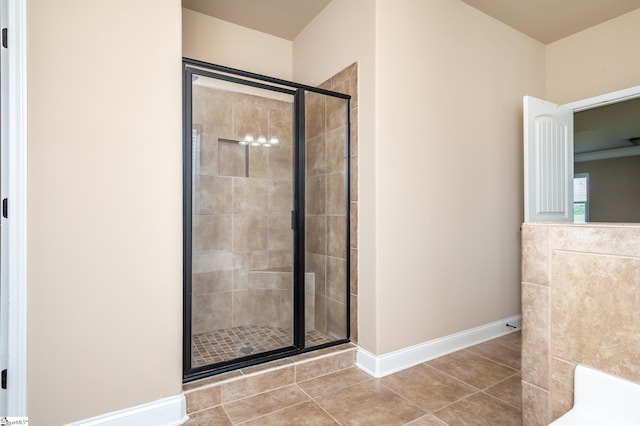 bathroom featuring a shower with shower door and tile patterned floors