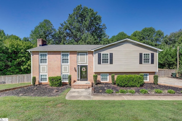 split foyer home with a front lawn