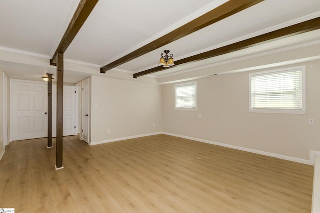 basement featuring crown molding and light hardwood / wood-style flooring