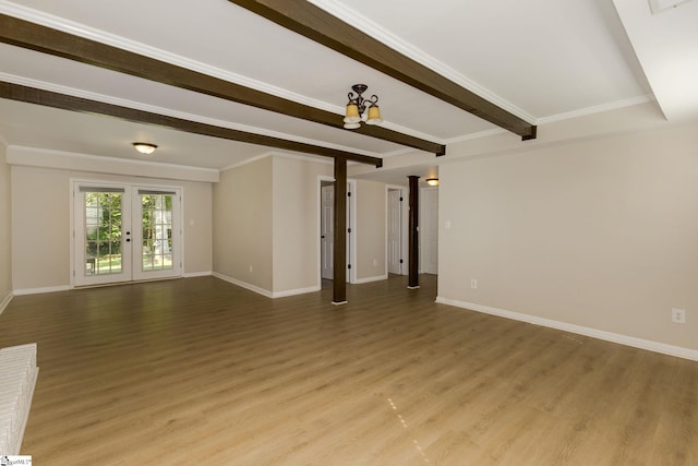 unfurnished living room featuring french doors, beamed ceiling, and light hardwood / wood-style floors