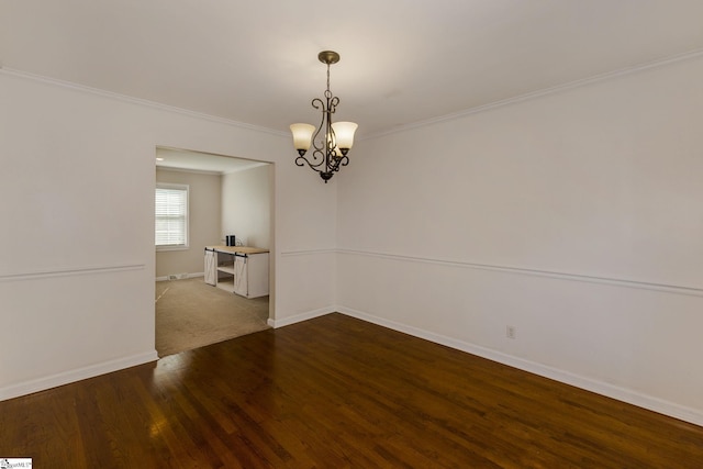 empty room with wood-type flooring, a notable chandelier, and ornamental molding