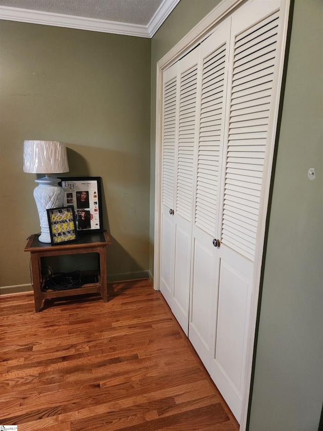 corridor with crown molding and hardwood / wood-style floors