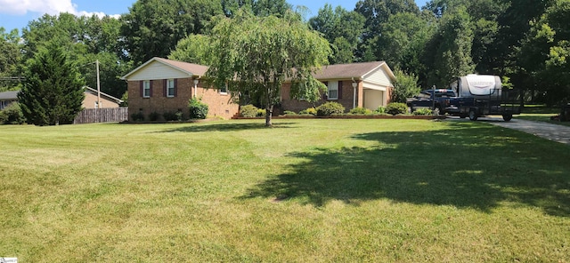 view of front of home with a garage and a front yard