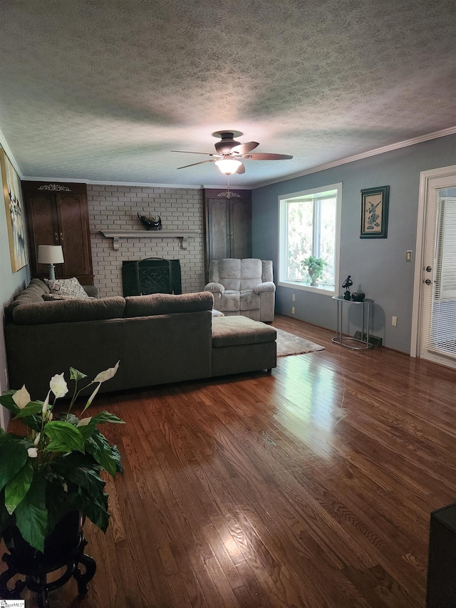 unfurnished living room with ceiling fan, a fireplace, dark hardwood / wood-style floors, and a textured ceiling