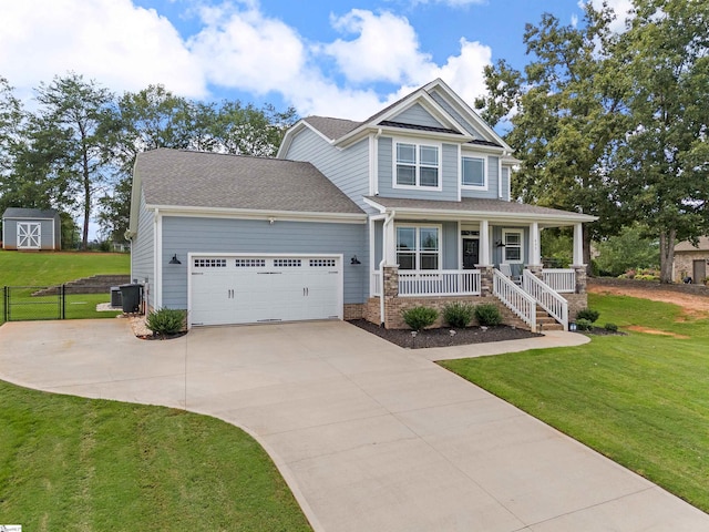 craftsman-style house featuring a garage, central air condition unit, a front lawn, and a porch