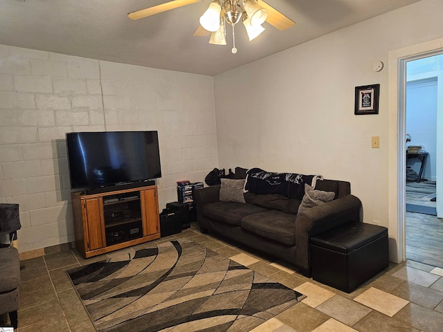 living room with ceiling fan and tile patterned flooring