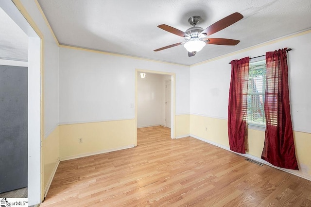 unfurnished room featuring ornamental molding, ceiling fan, and light hardwood / wood-style floors