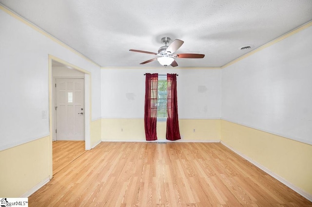 spare room with crown molding, a textured ceiling, light hardwood / wood-style flooring, and ceiling fan