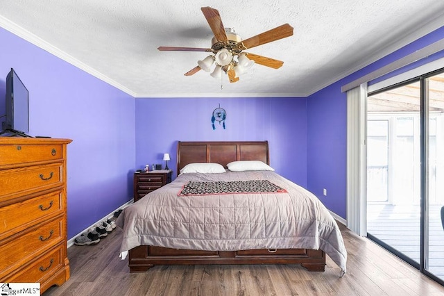 bedroom featuring a textured ceiling, ceiling fan, dark hardwood / wood-style floors, and access to outside