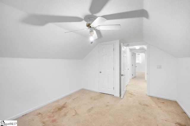 additional living space featuring lofted ceiling, ceiling fan, and light carpet