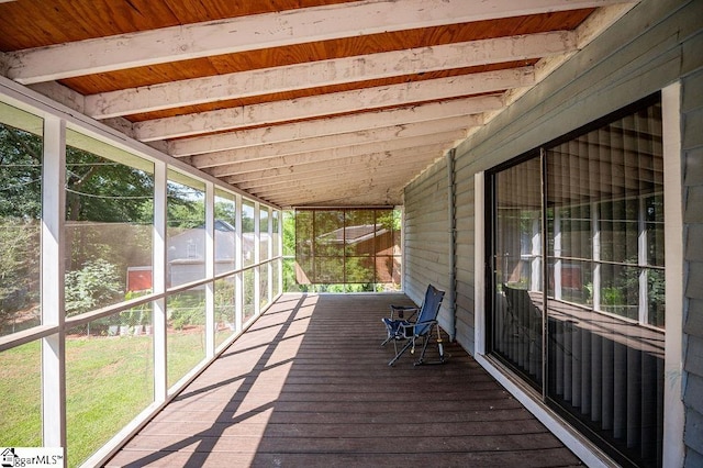 unfurnished sunroom featuring lofted ceiling and wood ceiling