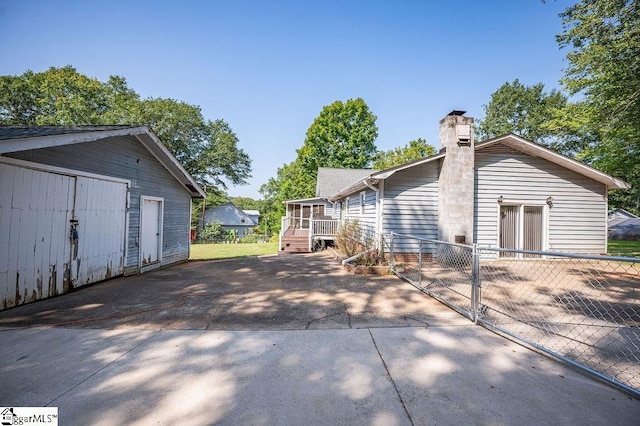 121 Sherman Ct, Piedmont, SC 29673 - back of property with an outdoor structure, fence, and a chimney