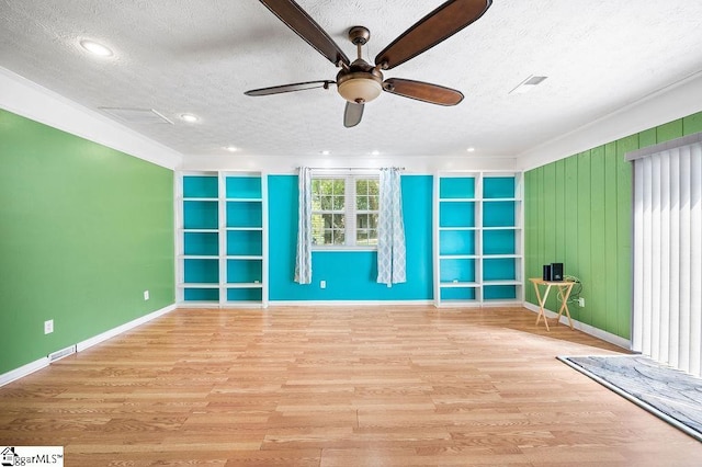 interior space featuring ceiling fan, light hardwood / wood-style floors, and a textured ceiling