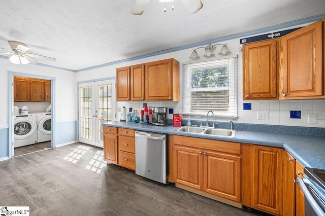 kitchen featuring washing machine and clothes dryer, ceiling fan, sink, and appliances with stainless steel finishes