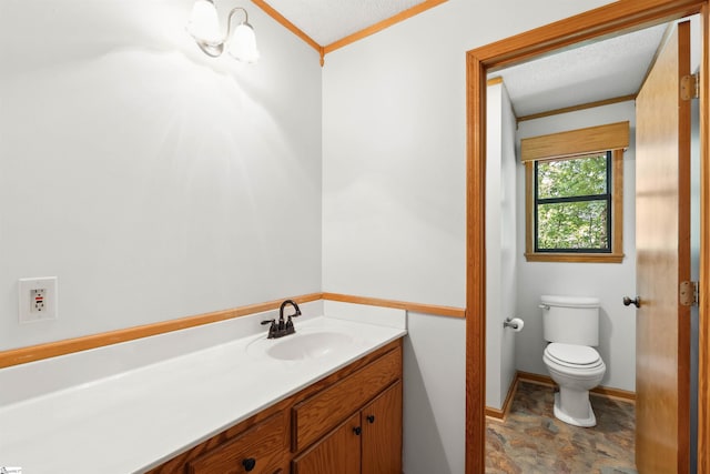 bathroom with vanity, toilet, crown molding, and a textured ceiling