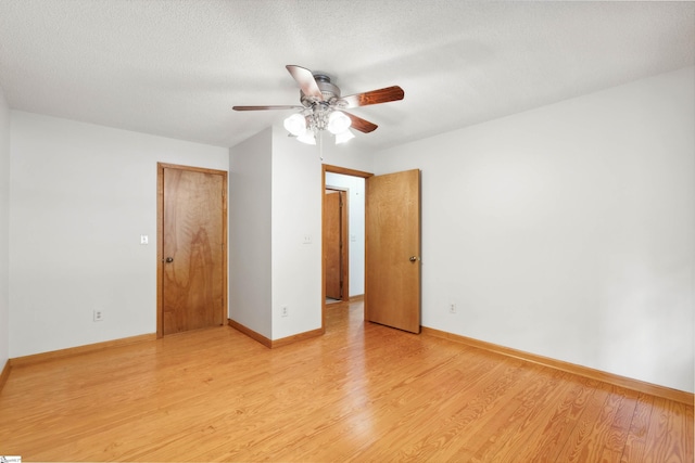 interior space featuring ceiling fan, a textured ceiling, and light hardwood / wood-style flooring