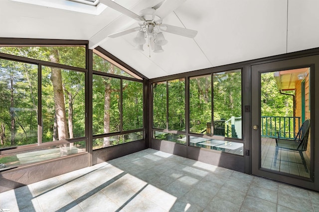 unfurnished sunroom with ceiling fan and vaulted ceiling with beams