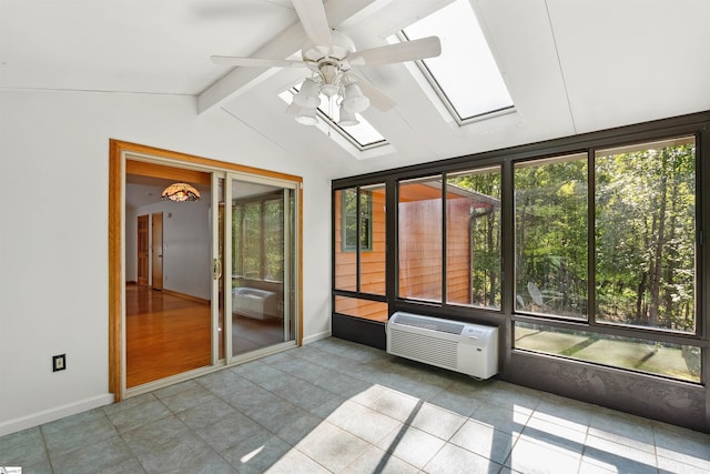 unfurnished sunroom featuring ceiling fan, a wall unit AC, and lofted ceiling with skylight