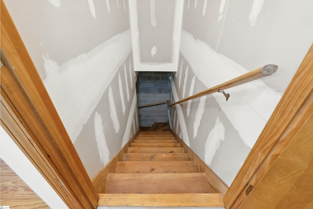 stairway with hardwood / wood-style flooring