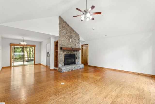 unfurnished living room featuring high vaulted ceiling, light hardwood / wood-style flooring, ceiling fan, and a stone fireplace