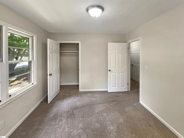 unfurnished bedroom featuring dark colored carpet