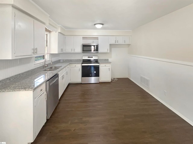 kitchen featuring dark hardwood / wood-style flooring, sink, appliances with stainless steel finishes, and white cabinetry