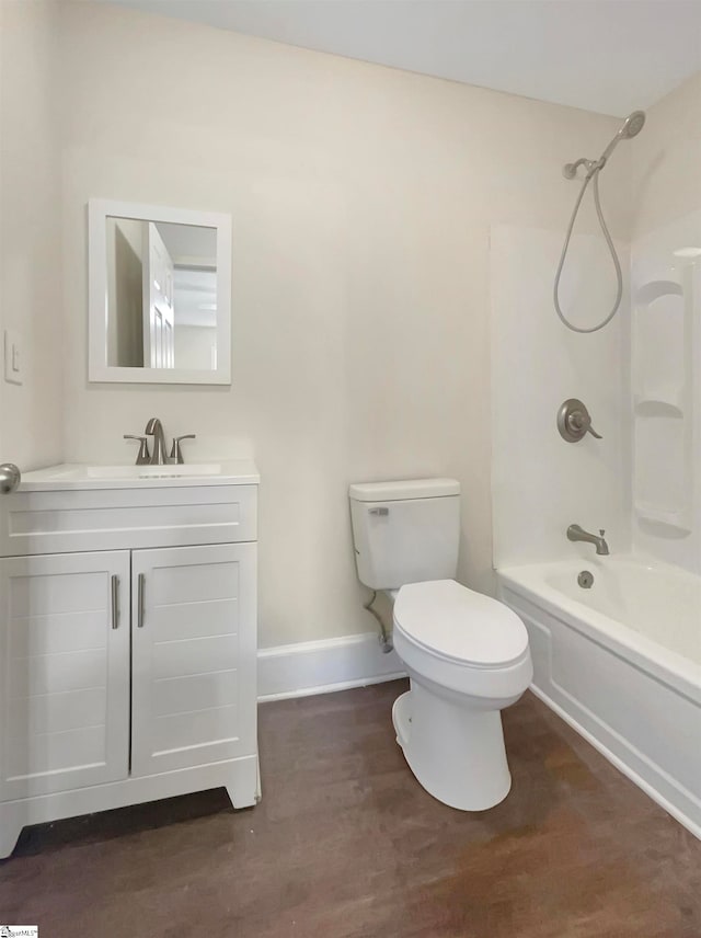 full bathroom with vanity, toilet, washtub / shower combination, and hardwood / wood-style flooring