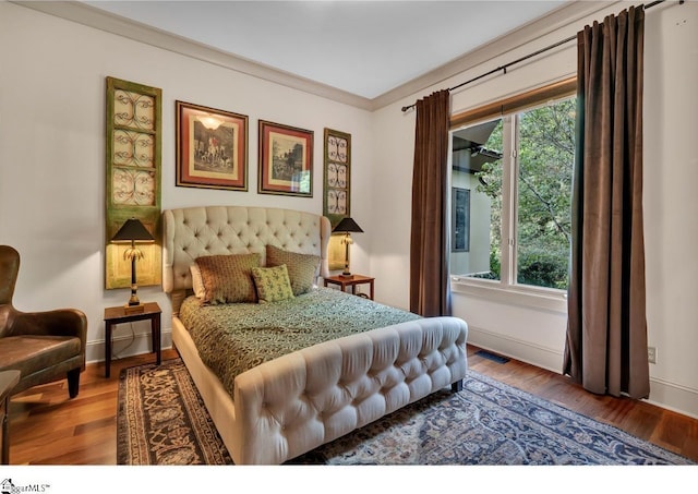 bedroom featuring ornamental molding and wood-type flooring