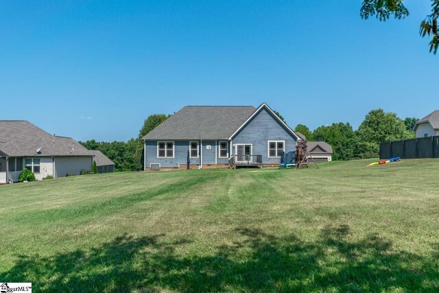 view of front of house featuring a front yard and a wooden deck