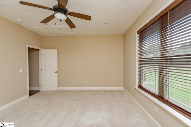 spare room featuring ceiling fan and light carpet