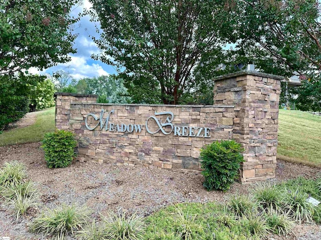 community / neighborhood sign with a lawn