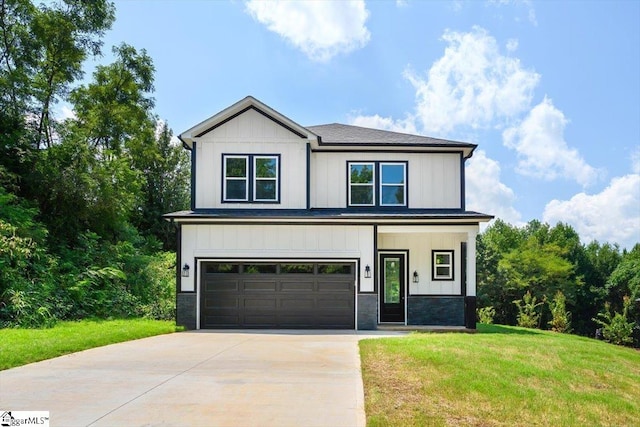 view of front facade with a front yard and a garage