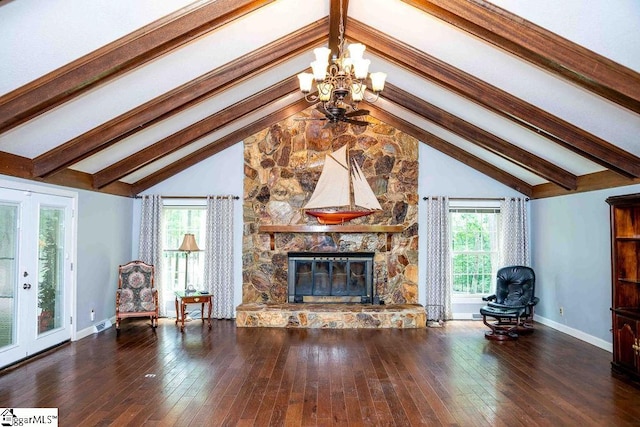 unfurnished living room featuring an inviting chandelier, a fireplace, dark hardwood / wood-style floors, and lofted ceiling with beams