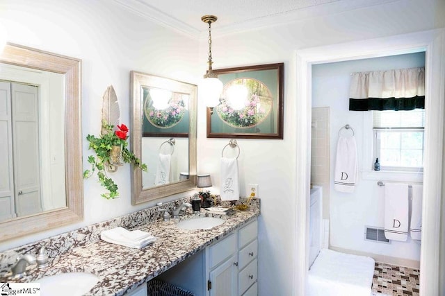 bathroom with crown molding and vanity