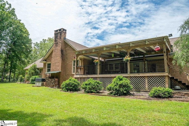 back of property featuring a yard and a pergola