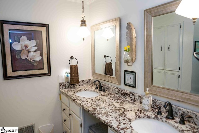 bathroom with ornamental molding and vanity