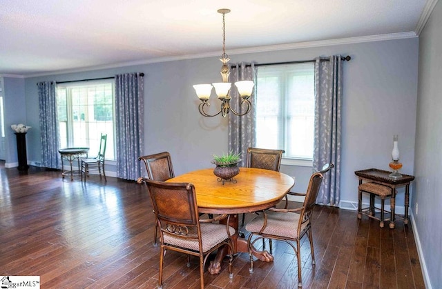 dining room with ornamental molding, dark hardwood / wood-style flooring, and a chandelier