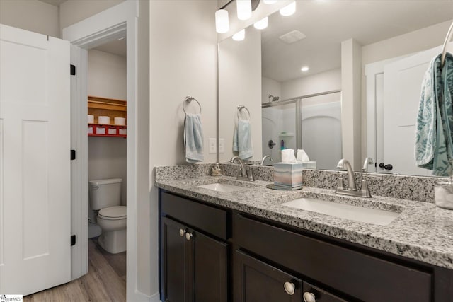 127 Addington Ln, Simpsonville, SC 29681 - bathroom featuring toilet, a sink, a stall shower, and wood finished floors