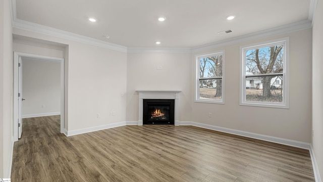 unfurnished living room featuring crown molding and hardwood / wood-style floors