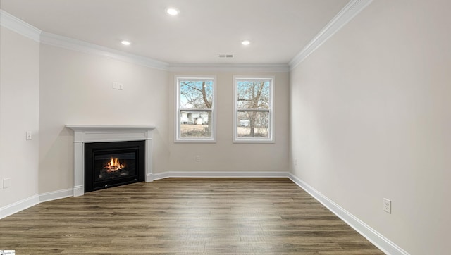 unfurnished living room featuring ornamental molding and dark hardwood / wood-style floors