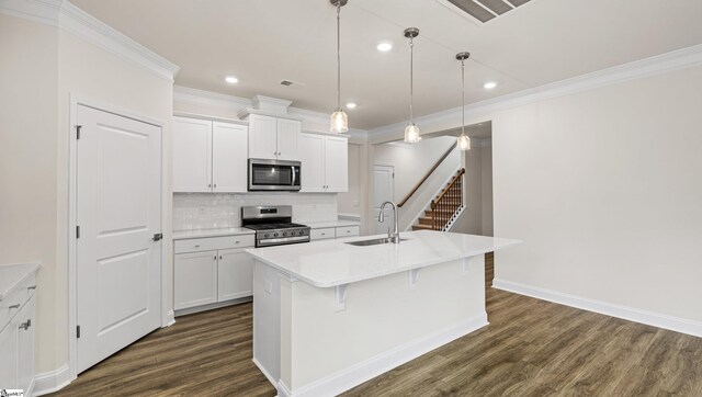 kitchen with white cabinetry, stainless steel appliances, sink, and a center island with sink