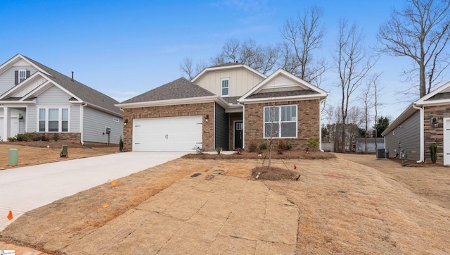 craftsman-style home featuring brick siding, central air condition unit, a shingled roof, concrete driveway, and an attached garage