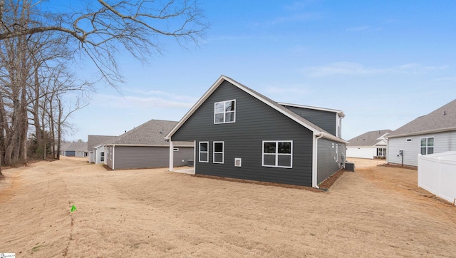 rear view of property featuring central AC unit