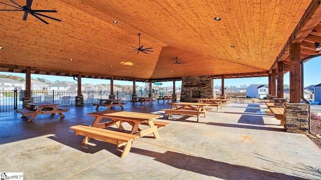 view of patio / terrace with an outdoor stone fireplace, a gazebo, and ceiling fan