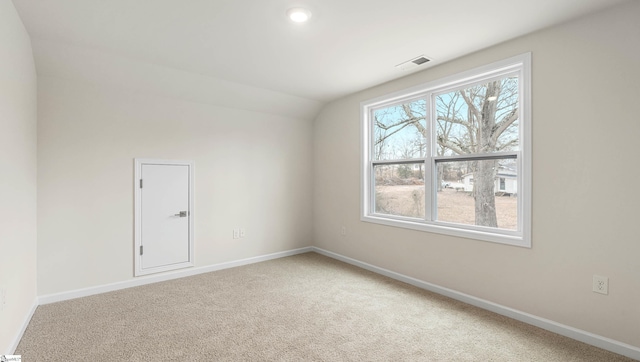 unfurnished room with carpet and lofted ceiling