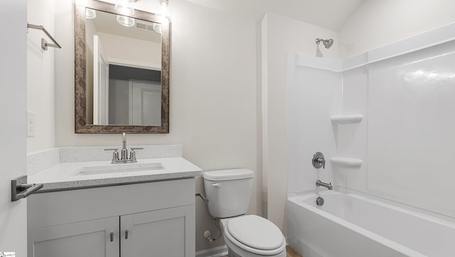 full bathroom featuring vanity, bathing tub / shower combination, and toilet